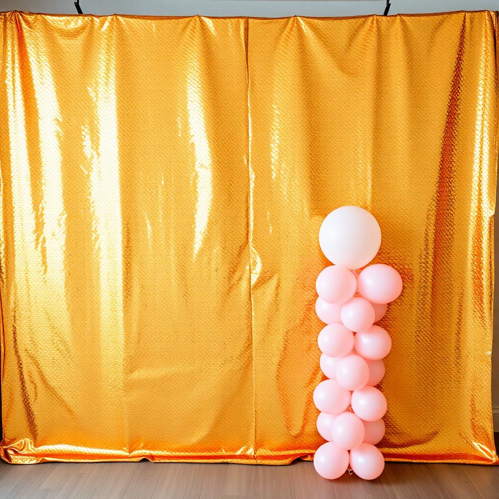 Gold sequin wall backdrop with blush balloon column